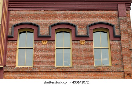 Three Windows in a Red Brick Wall