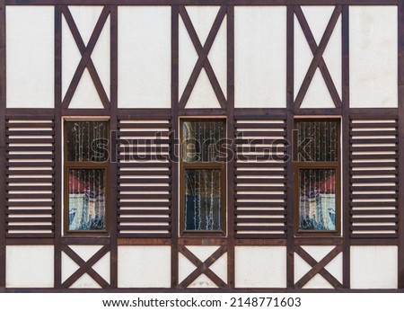 Three windows in a row on the facade of the modern urban apartment building front view, Krasnaya Polyana, Sochi, Krasnodar Krai, Russia