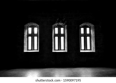 three windows viewed from inside an old house

