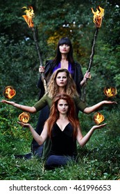 Three Witches Are Holding Balls Of Fire