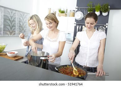 Three Women Cook In Kitchen