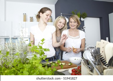 Three Women Cook In Kitchen