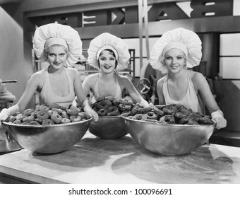 Three women with huge bowls of donuts