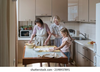 Three Women In The Kitchen Are Cooking Homemade Pies.