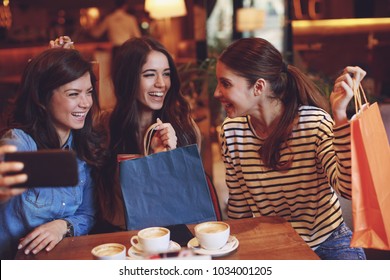 Three Women Making Selfie After Shopping In A Cafe