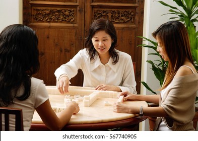 Three Women Playing Mahjong Together