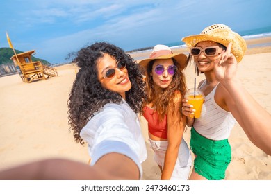 Three women are posing for a picture on the beach, with one of them holding a drink. Scene is lighthearted and fun, as the women are smiling and enjoying their time together - Powered by Shutterstock