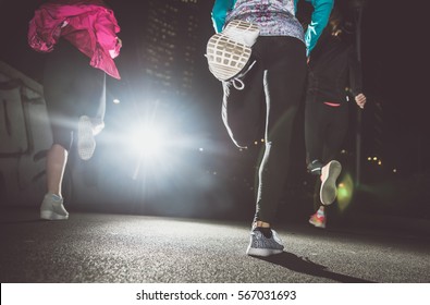 Three Women Running In The Night In The City Center