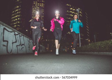 Three Women Running In The Night In The City Center