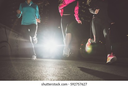 Three Women Running In The Night In The City Center