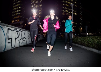 Three Women Running In The Night In The City Center