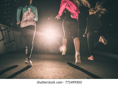 Three Women Running In The Night In The City Center