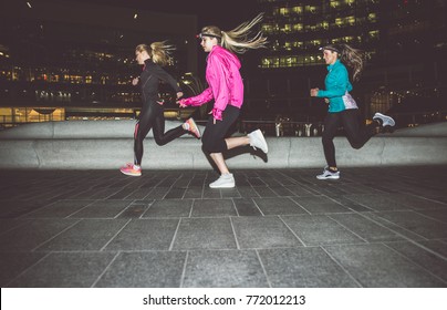 Three Women Running In The Night In The City Center