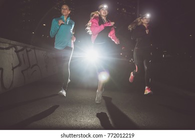 Three Women Running In The Night In The City Center