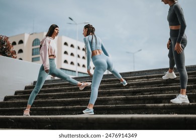 Three women in sportswear jogging up concrete steps, promoting exercise, wellness, and active lifestyle in the city. - Powered by Shutterstock