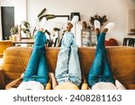 Three women standing upside down on the couch - Close up focus on legs