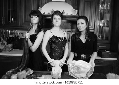 Three Women Together In The Kitchen With Products, The Housewife Is Cooking