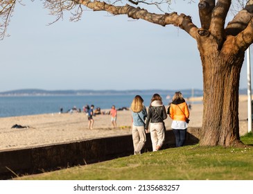 Three Women Walking On The Promenade By The Beach