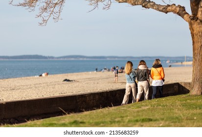 Three Women Walking On The Promenade By The Beach