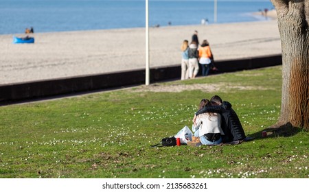 Three Women Walking On The Promenade By The Beach