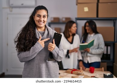 Three Women Working At Small Business Ecommerce Smiling Happy Pointing With Hand And Finger 