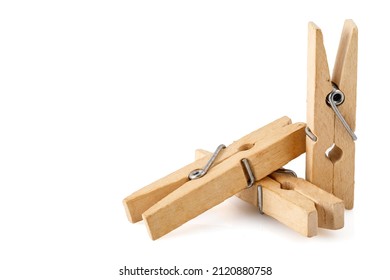 Three wooden clothespins, isolated on a white background, lie together. Close up photo. Full depth of field.