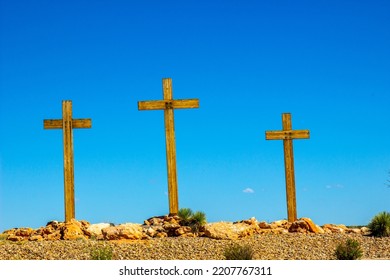 Three Wooden Crosses On Desert Hilltop