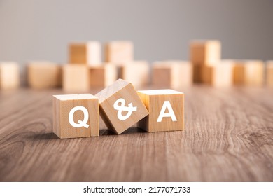 Three wooden cubes with the letters Q and A. questions and answers Q And A concept - Shutterstock ID 2177071733