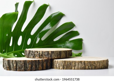Three wooden stage on a sheet with monsters for the presentation of eco-friendly products. The podium is made of natural material with space for text. Minimalistic branding scene. - Shutterstock ID 1964551738