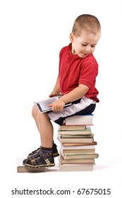 Three Year Old Boy Sitting On Pile Of Books, Reading