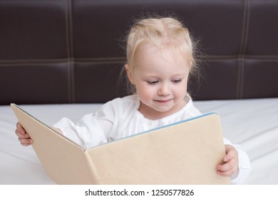 Three Year Old Girl Reading A Book