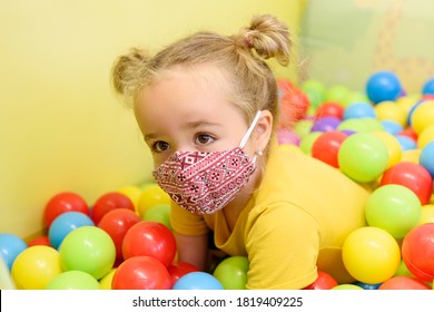 Three Year Old Girl Wearing Face Mask During Playing At Her Occupational Child Therapy Session. Covid-19 Epidemic Concept.