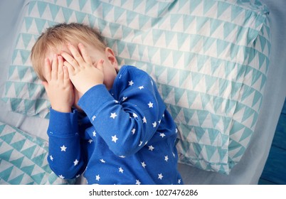 Three Years Old Child Crying In Bed. Boy Hiding And Closing Eyes With Hands