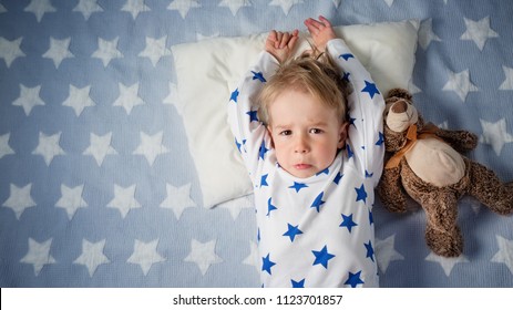 Three Years Old Child Crying In Bed. Sad Boy On Pillow In Bedroom