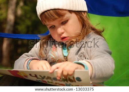 Similar – grandma reading a book to a child