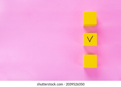 Three Yellow Cubes With A Tick On One On Pink. Copy Space. Concept Of Choosing A Better Option, Creating To Do Lists And Elections