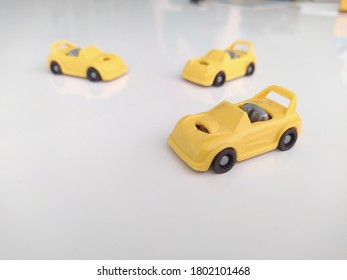 Three Yellow Toy Cars Macro