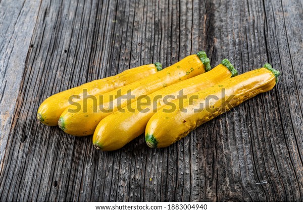 Three yellow zucchini isolated on a white\
background. Yellow courgettes. Yellow\
squash.