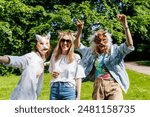 Three young adult beautiful woman girls friends enjoy have fun wearing animal mask laughing at picnic party city park green garden at sunny day. Female person friendship summer outdoors celebration.