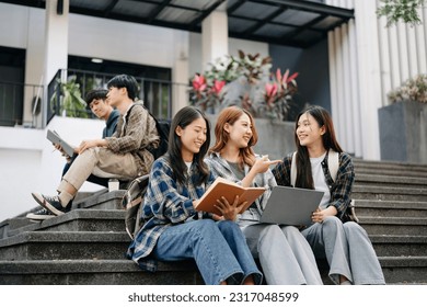 Three young Asian college students and a female student group work at the campus park in morning
 - Powered by Shutterstock