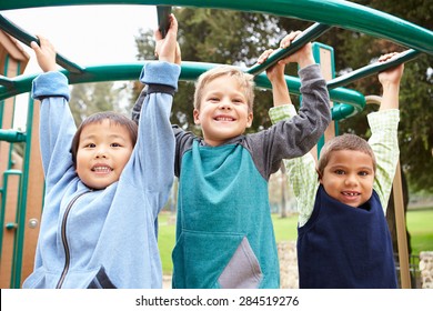 Three Young Boys On Climbing Frame In Playground - Powered by Shutterstock