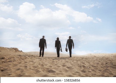 Three Young Business People Walking Through The Desert