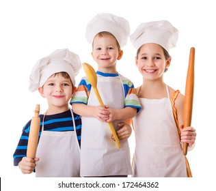 Three young chefs with ladle and rolling pin, isolated on white