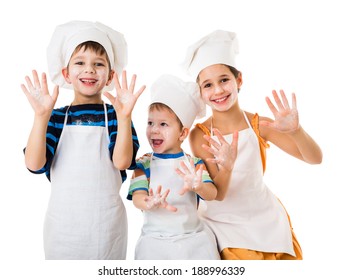 Three young chefs with raised hands in flour, isolated on white
