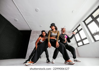 Three young fashionable African American and Hispanic dancers are in the studio practicing dancing moves. - Powered by Shutterstock