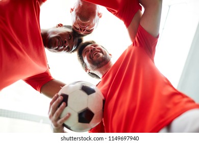 Three young footballers standing head to head close to each other symbolizing unity - Powered by Shutterstock