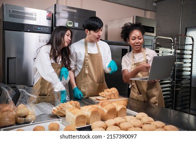 Three young friends and startup partners of bread dough and pastry foods busy with homemade baking jobs while cooking orders online, packing, and delivering on bakery shop, small business entrepreneur - Powered by Shutterstock