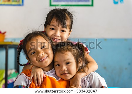 Three young girls girlfriends in a thai school. Thai school in a small village