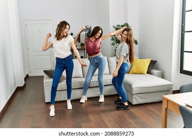 Three Young Hispanic Woman Smiling Happy And Dancing At Home.