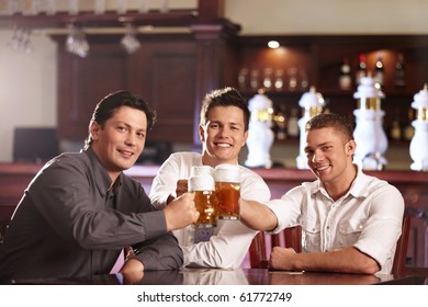 Three Young Men Bob Mugs In The Bar